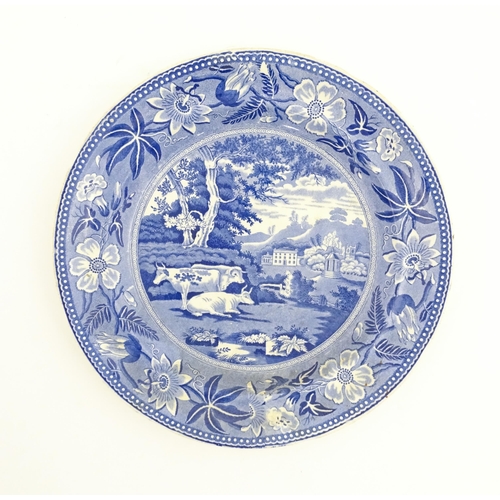 93 - A blue and white plate decorated in the Wiseton Hall pattern with cows resting in a landscape with a... 