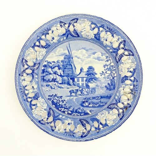 94 - A blue and white plate with a reticulated border decorated in the British Scenery pattern depicting ... 