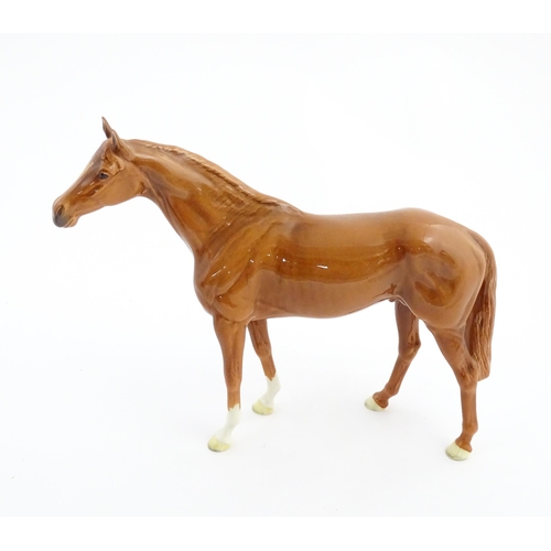 114 - A large Beswick model of a chestnut racehorse, model no. 1564. Marked under and numbered 95. Horse a... 