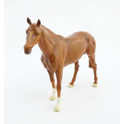 114 - A large Beswick model of a chestnut racehorse, model no. 1564. Marked under and numbered 95. Horse a... 