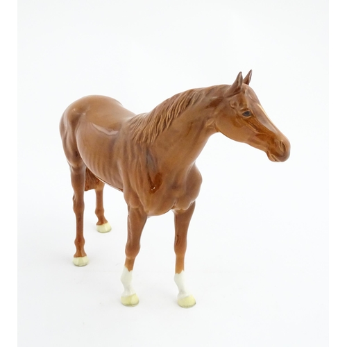 114 - A large Beswick model of a chestnut racehorse, model no. 1564. Marked under and numbered 95. Horse a... 