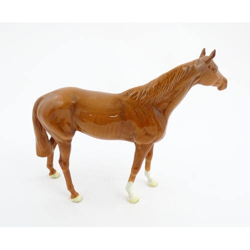 114 - A large Beswick model of a chestnut racehorse, model no. 1564. Marked under and numbered 95. Horse a... 