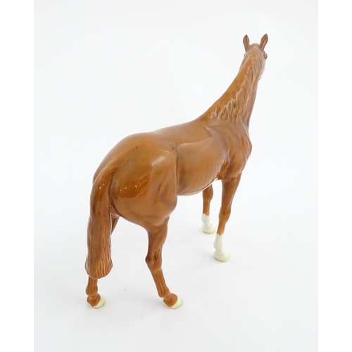 114 - A large Beswick model of a chestnut racehorse, model no. 1564. Marked under and numbered 95. Horse a... 