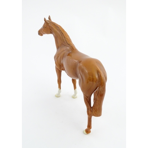 114 - A large Beswick model of a chestnut racehorse, model no. 1564. Marked under and numbered 95. Horse a... 