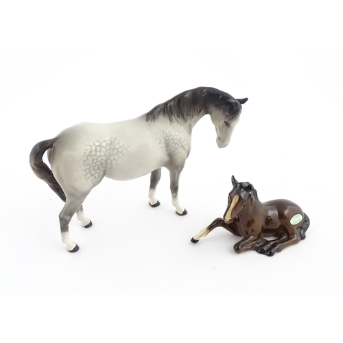 115 - Two Beswick models of horses comprising a foal no. 915 and a grey horse. Largest approx. 5 1/4