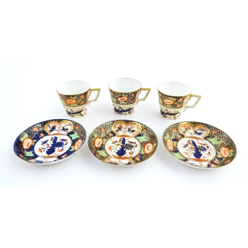 118 - Three Royal Crown Derby cups and saucers decorated in the Imari palette with floral and foliate deta... 