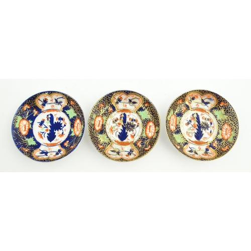 118 - Three Royal Crown Derby cups and saucers decorated in the Imari palette with floral and foliate deta... 