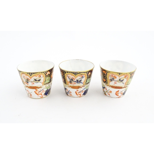 118 - Three Royal Crown Derby cups and saucers decorated in the Imari palette with floral and foliate deta... 