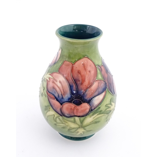 119 - A Moorcroft vase decorated in the Anemone pattern. Marked under. Approx. 7 1/2