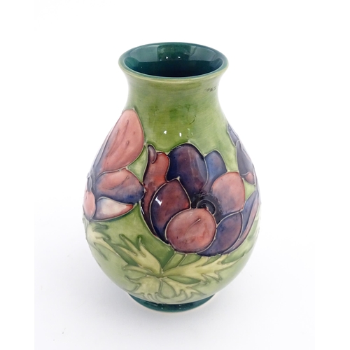 119 - A Moorcroft vase decorated in the Anemone pattern. Marked under. Approx. 7 1/2