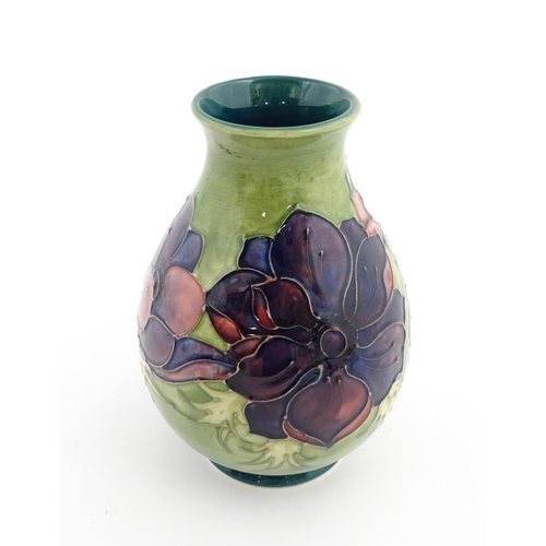 119 - A Moorcroft vase decorated in the Anemone pattern. Marked under. Approx. 7 1/2