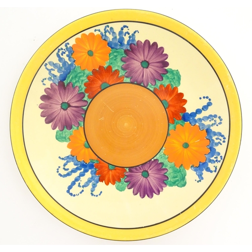 123 - A Clarice Cliff Bizarre plate decorated in the Gayday pattern. Marked under. Approx. 9