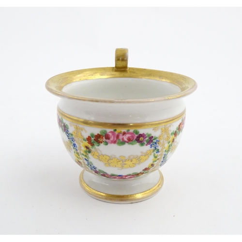 126 - A 19thC hand painted plate, cup and saucer decorated with floral swags and gilt scrolls. The plate i... 