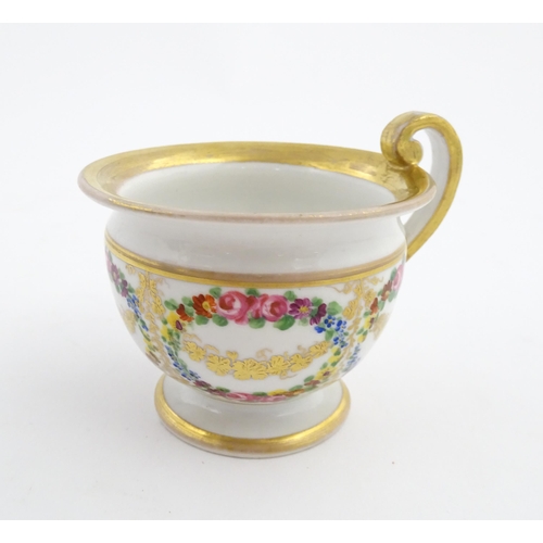 126 - A 19thC hand painted plate, cup and saucer decorated with floral swags and gilt scrolls. The plate i... 