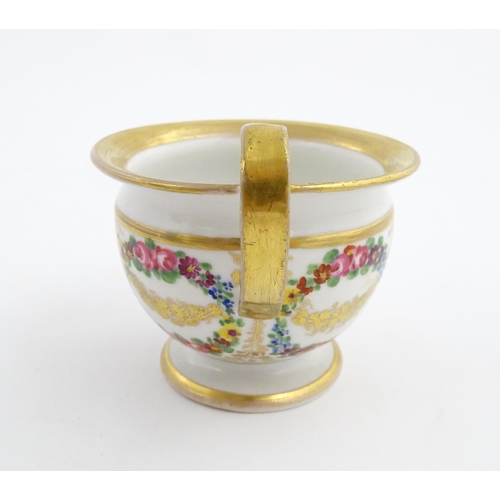 126 - A 19thC hand painted plate, cup and saucer decorated with floral swags and gilt scrolls. The plate i... 