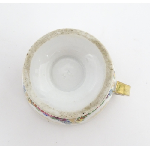 126 - A 19thC hand painted plate, cup and saucer decorated with floral swags and gilt scrolls. The plate i... 