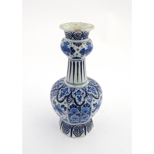 130 - A Dutch Royal Delft blue and white garlic neck vase with floral and foliate decoration. Marked under... 