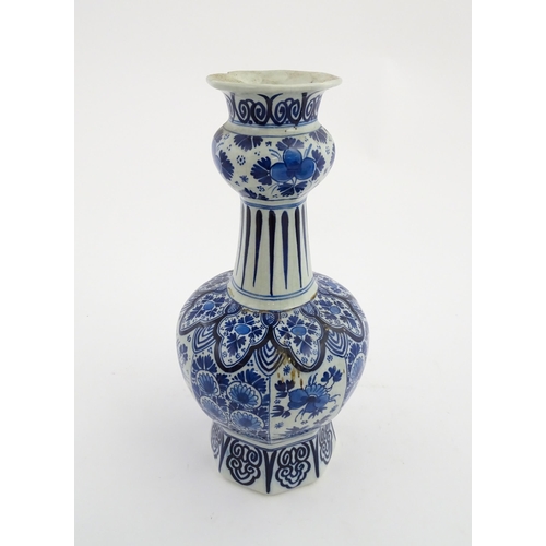 130 - A Dutch Royal Delft blue and white garlic neck vase with floral and foliate decoration. Marked under... 