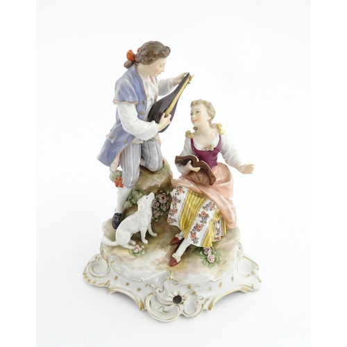 133 - A Continental figural group The Serenade, modelled as a gentleman playing a mandolin with a dog to s... 