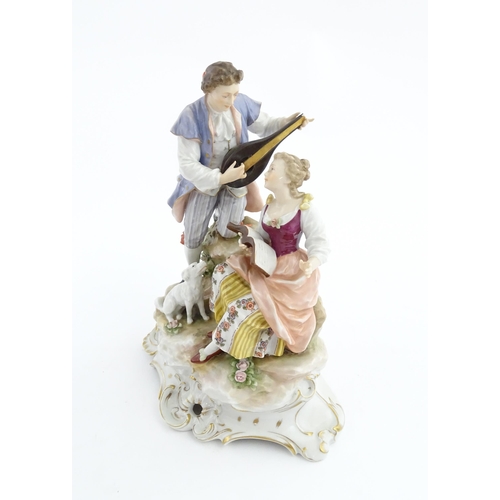 133 - A Continental figural group The Serenade, modelled as a gentleman playing a mandolin with a dog to s... 