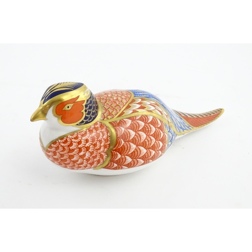 141 - A Royal Crown Derby paperweight modelled as a Pheasant. Marked under. Approx. 6 3/4