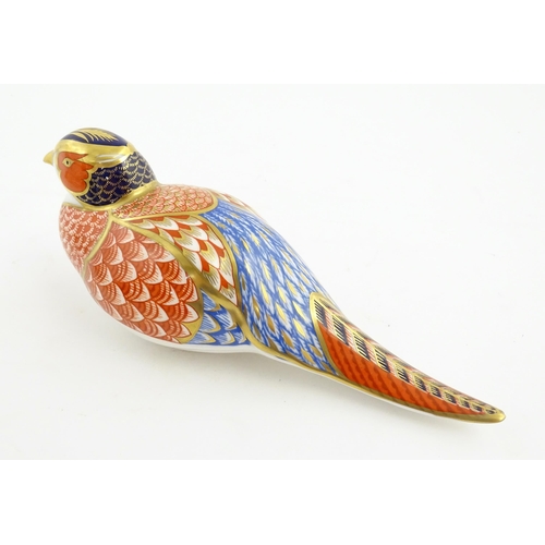 141 - A Royal Crown Derby paperweight modelled as a Pheasant. Marked under. Approx. 6 3/4