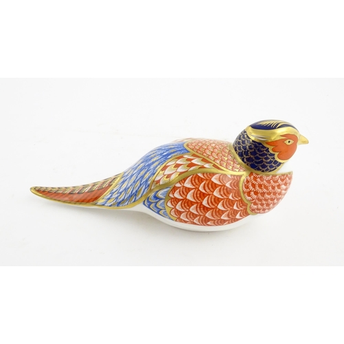 141 - A Royal Crown Derby paperweight modelled as a Pheasant. Marked under. Approx. 6 3/4