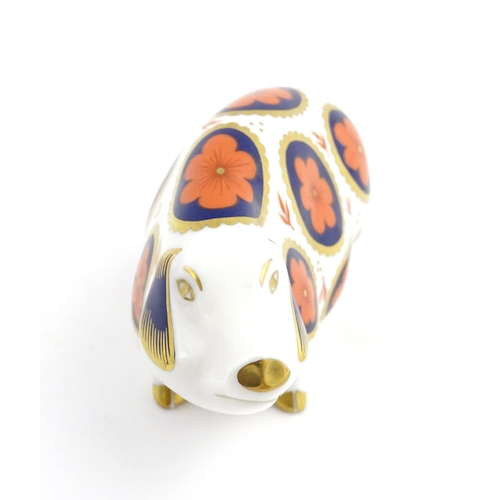 142 - A Royal Crown Derby paperweight modelled as a pig with flower detail. Marked under. Approx. 5 1/4