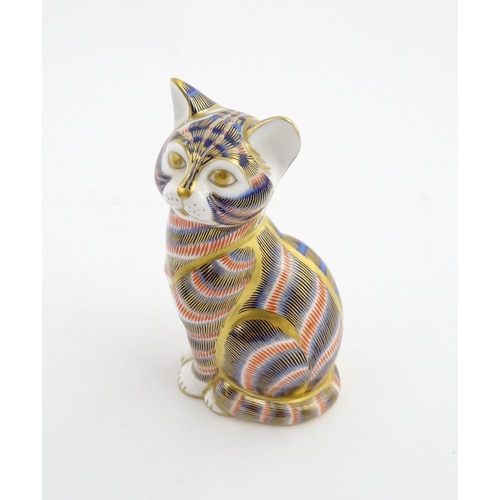 143 - A Royal Crown Derby paperweight modelled as a seated cat. Marked under. Approx. 5