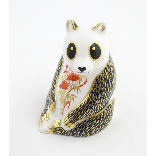 148 - A Royal Crown Derby paperweight modelled as a panda. Marked under. Approx. 4