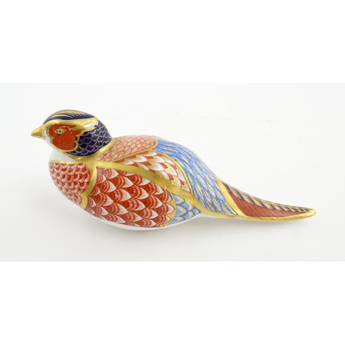 150 - A Royal Crown Derby paperweight modelled as a pheasant. Marked under. Approx. 6 3/4