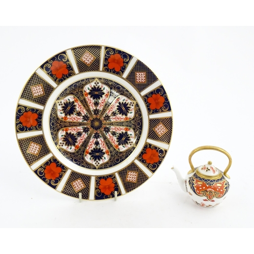 151 - A Royal Crown Derby plate and a miniature teapot decorated in the Imari palette. Marked under. Teapo... 