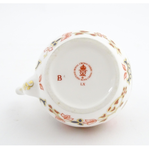 151 - A Royal Crown Derby plate and a miniature teapot decorated in the Imari palette. Marked under. Teapo... 