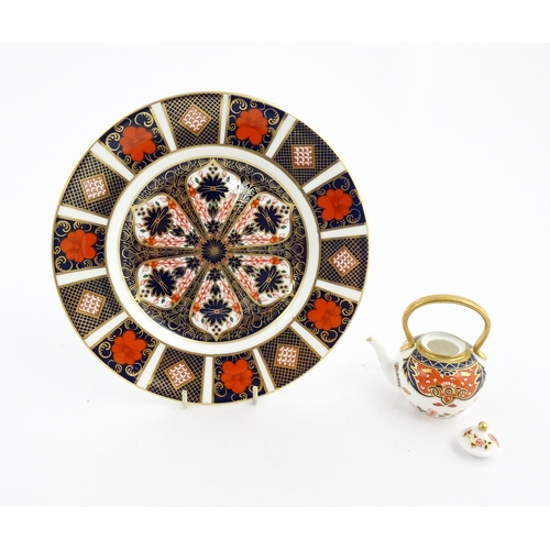 151 - A Royal Crown Derby plate and a miniature teapot decorated in the Imari palette. Marked under. Teapo... 