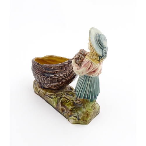 154 - A Victorian Torquay majolica pottery table salt modelled as a fisher girl with a net. Marked under W... 