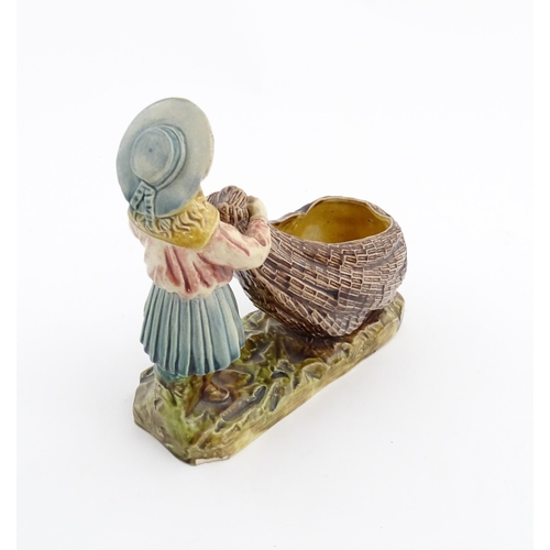 154 - A Victorian Torquay majolica pottery table salt modelled as a fisher girl with a net. Marked under W... 