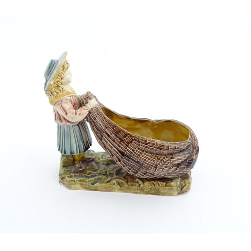 154 - A Victorian Torquay majolica pottery table salt modelled as a fisher girl with a net. Marked under W... 