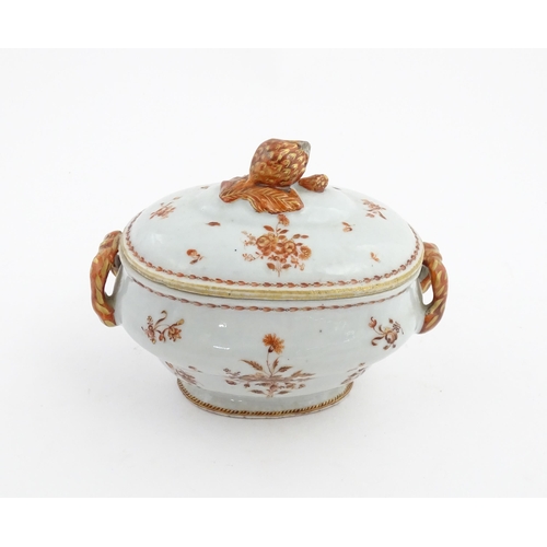 156 - Two items of porcelain decorated with orange flowers on a white ground, comprising a lidded sugar bo... 