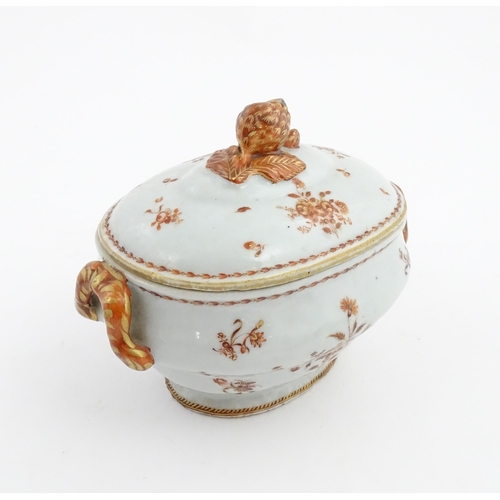 156 - Two items of porcelain decorated with orange flowers on a white ground, comprising a lidded sugar bo... 