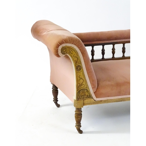 1580 - An early 20thC chaise longue with a scrolled end decorated with carved floral decoration and raised ... 