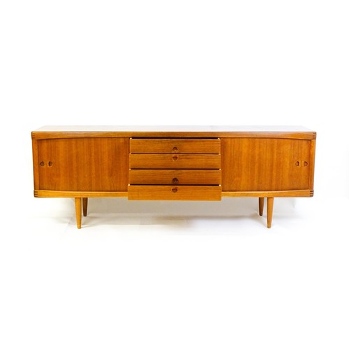 1648 - Vintage / Retro: A Danish teak sideboard designed by H.W.Klein for Bramin. With a bank of four drawe... 