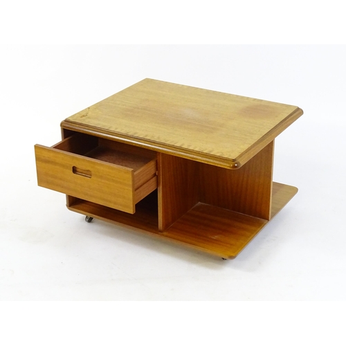 1656 - Vintage / Retro: A teak Meredew coffee table raised on four castors.  29