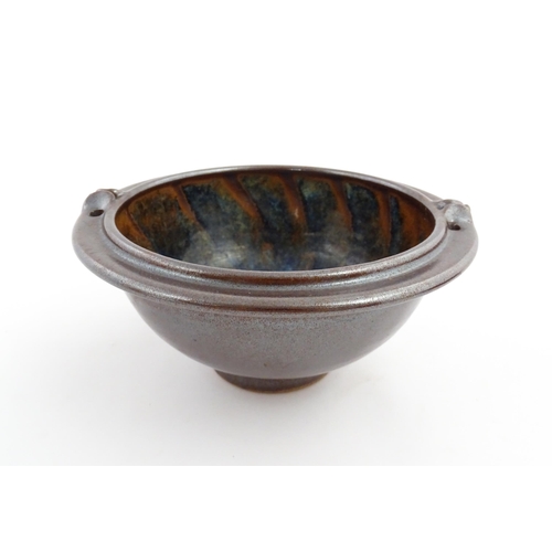 180 - A John Harlow studio pottery bowl with handle detail to rim. Stamped under John Harlow Somerset. App... 