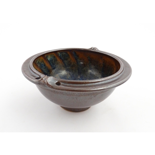 180 - A John Harlow studio pottery bowl with handle detail to rim. Stamped under John Harlow Somerset. App... 