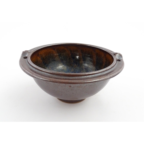 180 - A John Harlow studio pottery bowl with handle detail to rim. Stamped under John Harlow Somerset. App... 