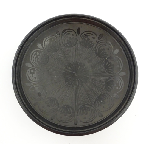 183 - A studio pottery dish with central flower detail and brushwork decoration. Incised under and signed ... 