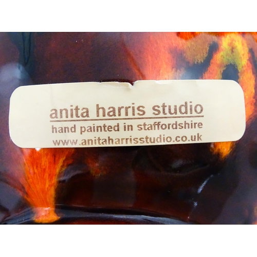 184 - Two Anita Harris Studio pottery vases with orange grounds and black detail. Both with artist initial... 