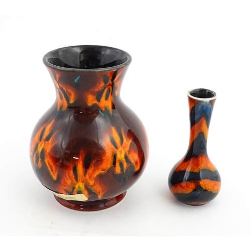 184 - Two Anita Harris Studio pottery vases with orange grounds and black detail. Both with artist initial... 