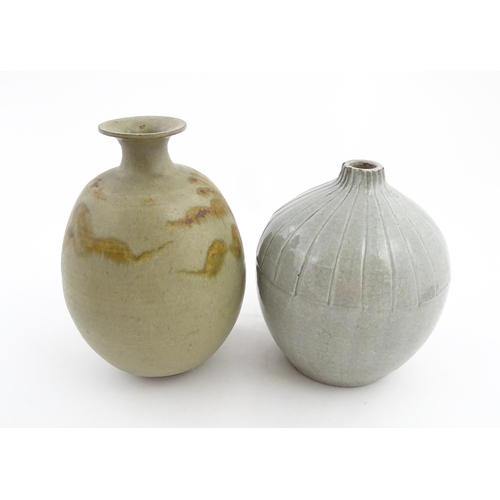 188 - A studio pottery vase with a flared rim and stylised floral detail. Together with a vase of globular... 