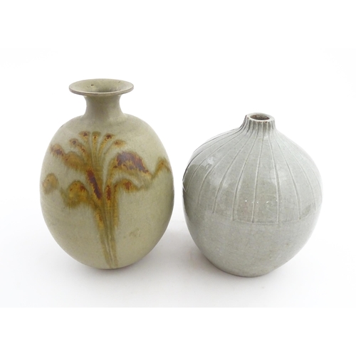 188 - A studio pottery vase with a flared rim and stylised floral detail. Together with a vase of globular... 